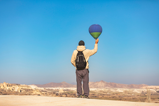Man holding hot air balloon in Cappadocia