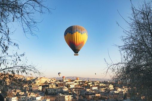 Hot air balloons flying above the village Goreme in Cappadocia