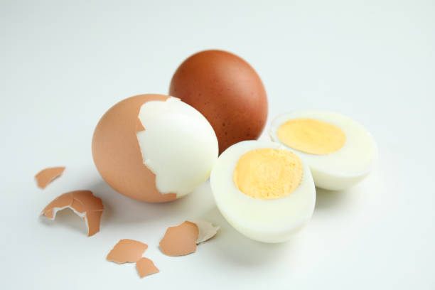 istock Hard boiled eggs and pieces of shell on white background 1473990816