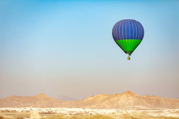 istock Hot air balloon flying over mountains in Cappadocia 1473990821