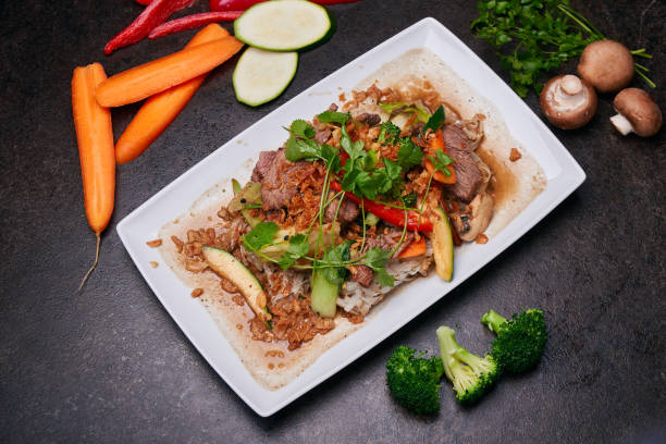 istock Fried rice with vegetables. Pan-asian dish top view on a dark table 1473990841