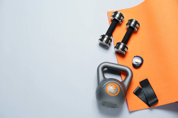 istock Exercise mat and other sport equipment on white background, flat lay. Space for text 1473992369