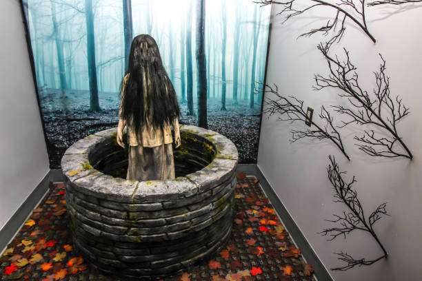 Small Girl Coming Out Of Well At Horror Shop Girl In A Well Display At Local Horror Shop thomas wells stock pictures, royalty-free photos & images