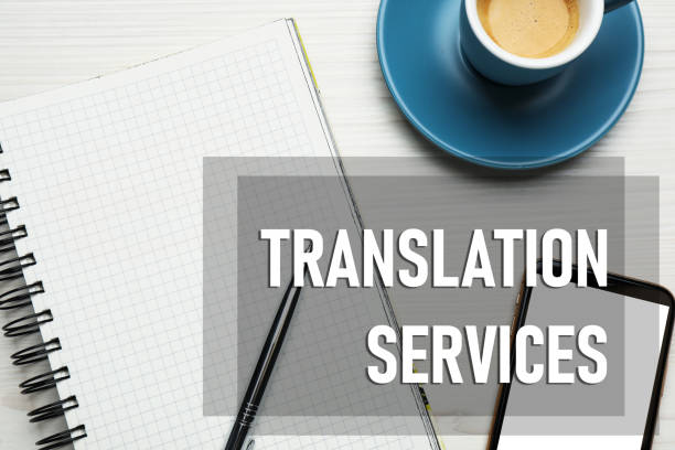 istock Translation services. Flat lay composition with notebook on white wooden table 1473992746