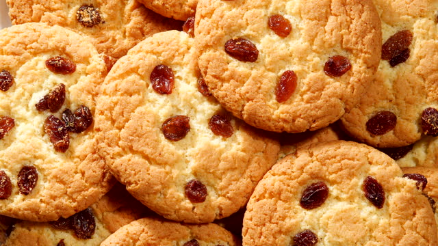 Cookies with Pieces of Raisin, Rotation. Homemade Piece Biscuit  Top View Rotating Video. American Cookies Close Up. Concept of Dessert, Snack, Bakery, Food, Unhealthy Food
