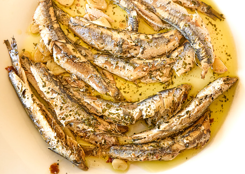 Fresh fried sardines with garlic and olive oil