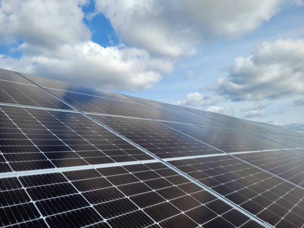 istock Photovoltaic panels against a blue sky with clouds. 1473998469