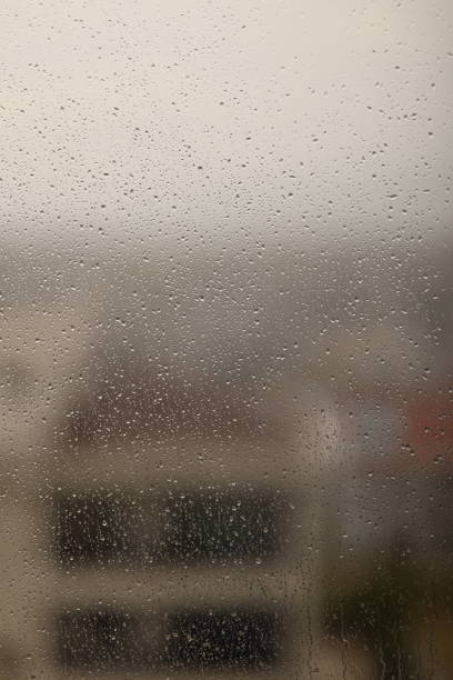 istock Rain drops on window glass outside 1473999161