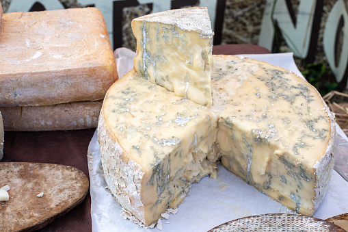 Gorgonzola, typical Italian blue cheese, displayed at the market stall. Organic food. High quality photo