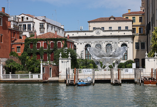 Venice, Italy - September 5, 2022: Baby 3.0 the monumental sculpture by Lorenzo Quinn in the garden of Ca Corner della Ca Granda palace in Venice.