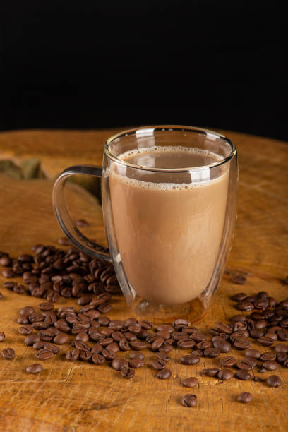 istock Glass cup, glass cup with milk and coffee on rustic wood, selective focus. 1474002003