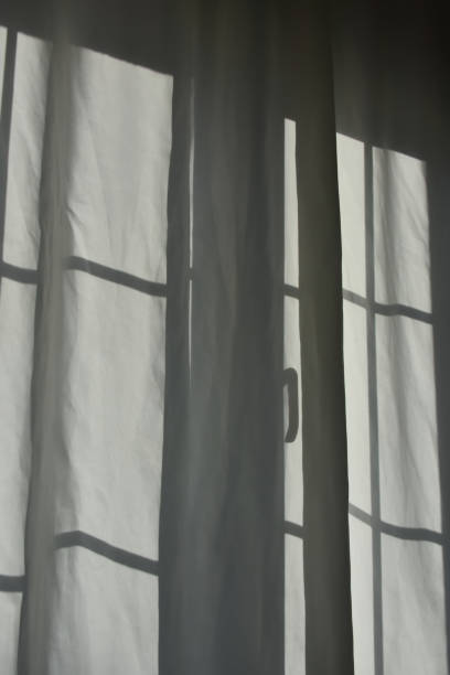 istock Window shadow on curtain, window and curtain in backlight 1474002271