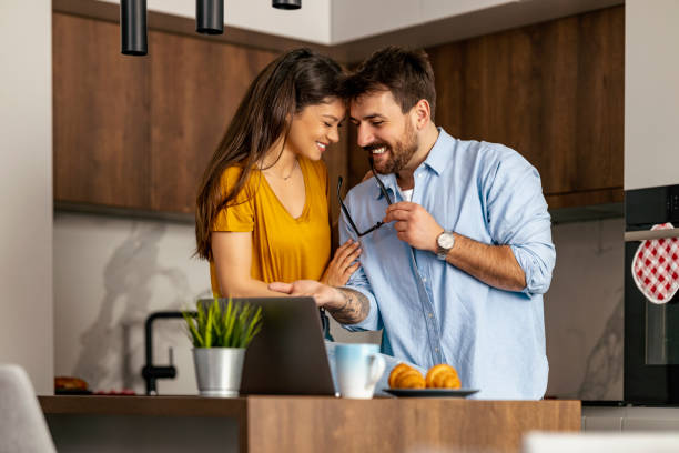 istock Loving couple drinking coffe in the kitchen 1474004582