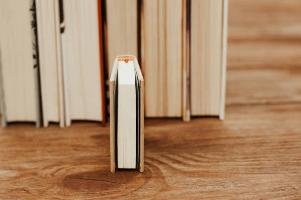 istock A stack of books stand on the tables, stacked in the frame, next to small mini books 1474006176