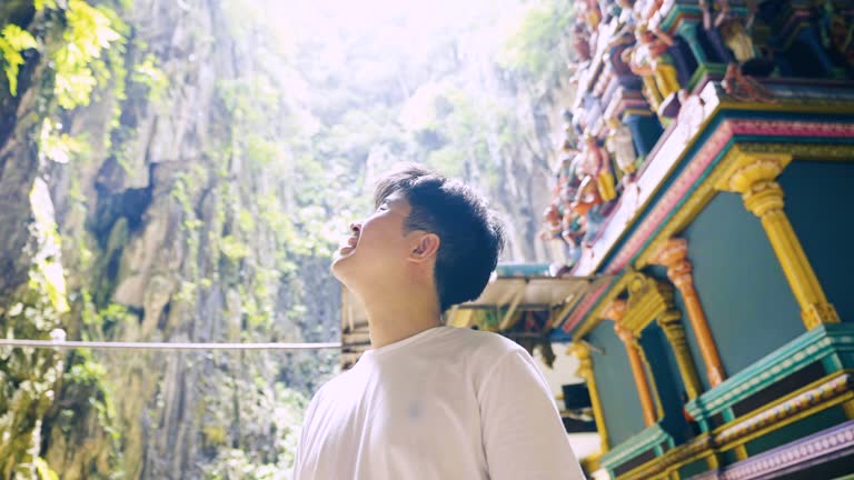 Tourist looking up the cave in Batu caves