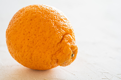 Dekopon citrus is a seedless orange-satsuma- mandarin crossbreed known for easy peeling and exceptional sweetness. Originating in Japan, the fruit is now grown in the San Joaquin Valley of California and sold under the trademark of Sumo Citrus.