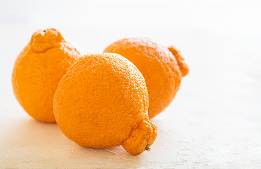 Dekopon citrus is a seedless orange-satsuma- mandarin crossbreed known for easy peeling and exceptional sweetness. Originating in Japan, the fruit is now grown in the San Joaquin Valley of California and sold under the trademark of Sumo Citrus.
