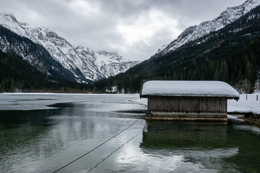 Winter partly frozen lake Jagersee in Austria. Snowy winter mountains in the Alps.