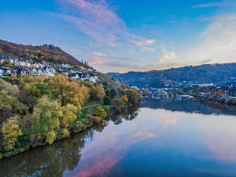 Cochem town on both sides of Moselle river after sunset during colourful autumn season in Cochem-Zell district, Germany