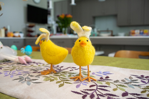 This is a photo of stuffed baby chicks with bunny ears placed on the table awaiting brunch to start.