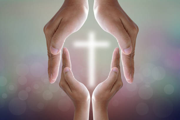 istock Human hands protecting the cross 1474014616