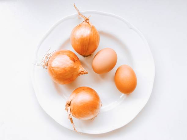 istock Onions and Eggs on a White Plate 1474017210