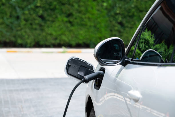 istock Closeup EV car and charger with blur background for progressive concept. 1474017290