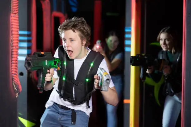 Photo of Young guy playing lasertag in arena