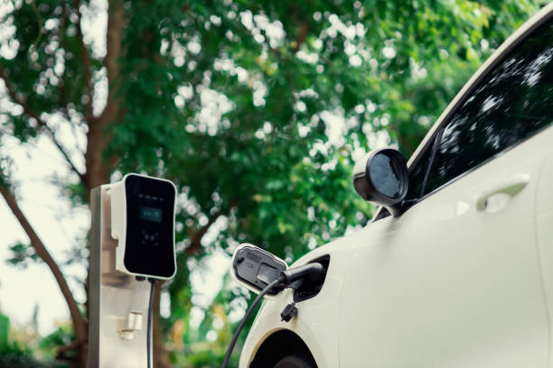 istock Focus closeup EV car and charger with blur background for progressive concept 1474019685