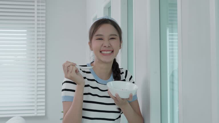 healthy food. Beautiful female girl enjoy eat yogurt, granola, fresh fruits on breakfast health in house. Happy young woman smile on morning good emotion. dieting, detox, diet, clean eat, vegetarian