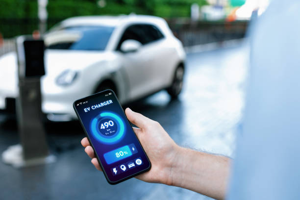 istock Closeup progressive idea hand holding smart phone display EV's batter status. 1474022010