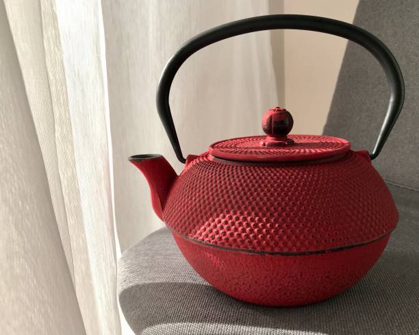 istock red clay teapot on beige background under sunlight 1474023191