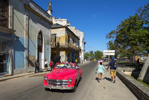Havana, Cuba, November 20, 2017: A car is going down the street in the center of Cuban capital on a sunny day.