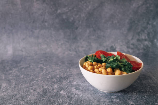 veggie poke filled with chickpeas, arugula and tomato, copy space