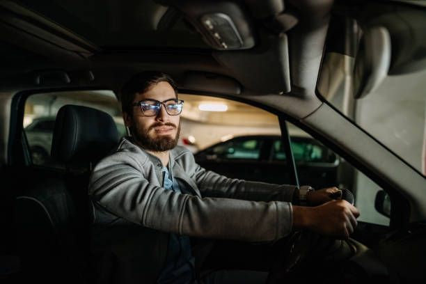istock Young man in the car 1474025403