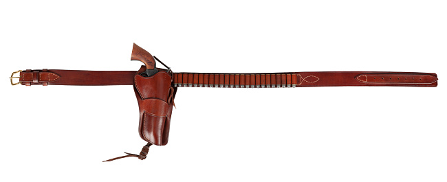 Old west weapon. Leather gun belt with ammnunitions and revolver in holster isolated on white background
