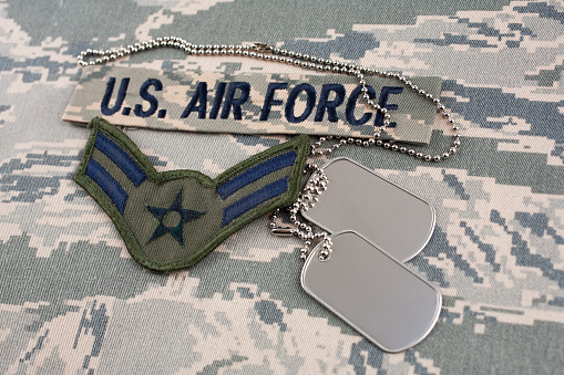 US AIR FORCE branch tape and Airman First Class rank patch and dog tags on digital tiger-stripe pattern Airman Battle Uniform (ABU)