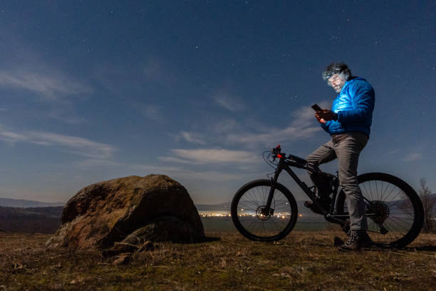 istock Winter outdoor workout. Man cycling at night. 1474028553