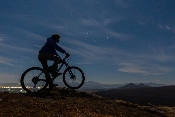 istock Winter outdoor workout. Man cycling at night. 1474028554