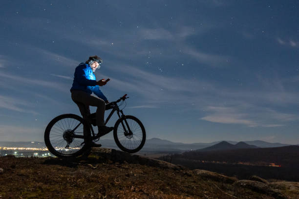 istock Winter outdoor workout. Man cycling at night. 1474028555
