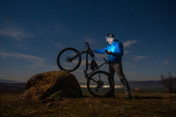 istock Winter outdoor workout. Man cycling at night. 1474028556