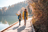 Mid Adult Caucasian Woman With Her  Daughter Walking Around Lake Bled