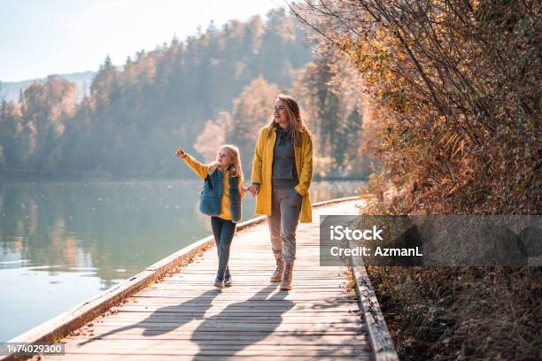 Mid Adult Caucasian Woman With Her Daughter Walking Around Lake Bled Stock Photo - Download Image Now