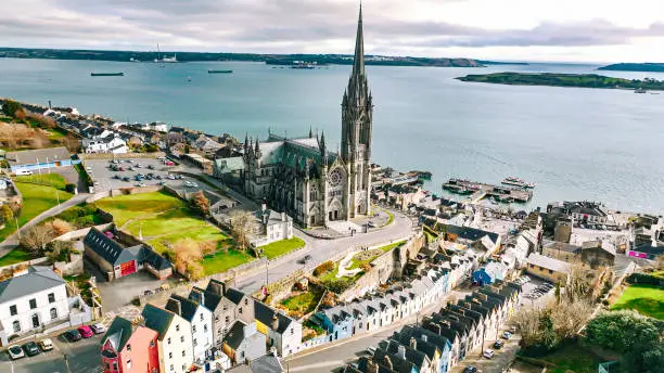 Photo of Aerial view of the Cathedral and colored houses in Cobh, Ireland ,colorful houses and St Colman's Cathedral in Cobh, Houses and catherdral in Cobh, colorful town