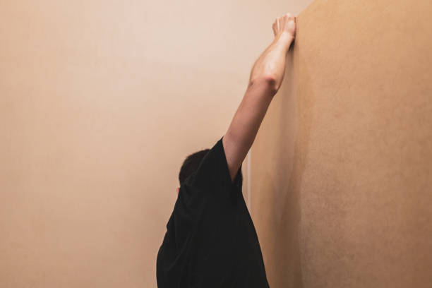 istock A young man installs plywood from a closet. 1474033171