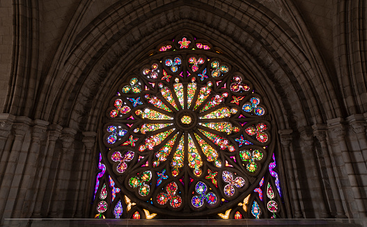 Sunlight pouring through stained glass windows of a church in Kaysersberg France