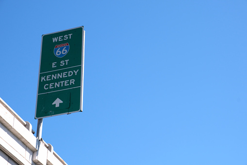 Highway sign in Washington DC against blue sky.