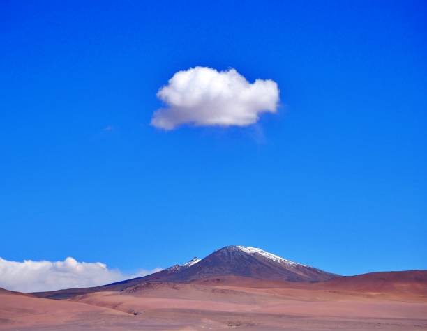 a cloud over a volcano in the sky in the Altiplano