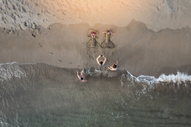 istock Family playing on sand breach 1474040566