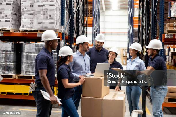 Business Manager Talking To A Group Of Employees At A Distribution Warehouse Stock Photo - Download Image Now